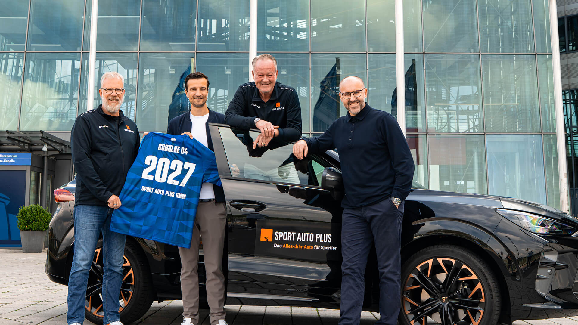 Ralph Wershoven und Stephan Penz von Sport Auto Plus und Vertretern von Schalke 04 stehen gemeinsam vor der Veltins Arena